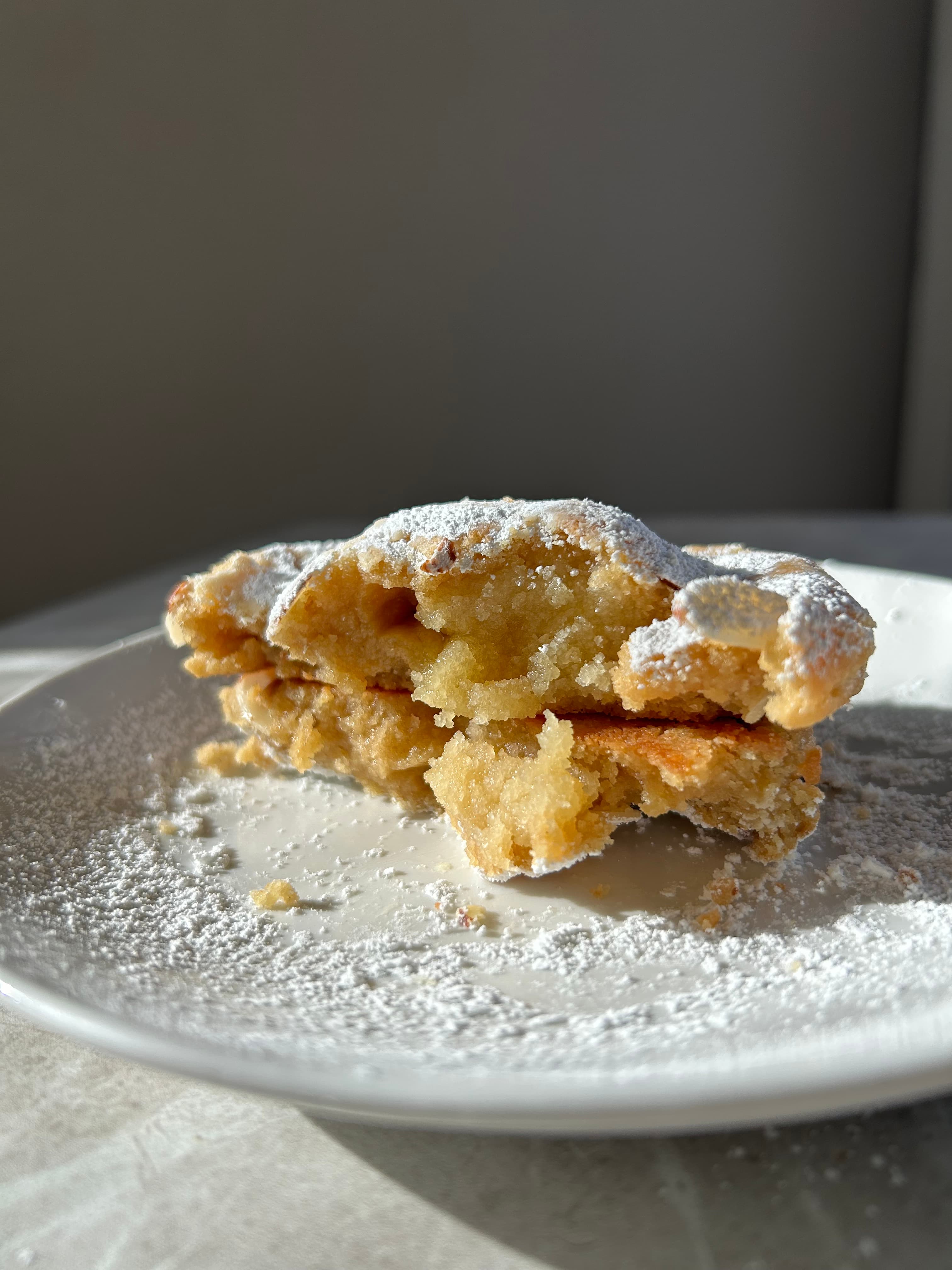 Almond Croissant Cookie Stuffed With Frangipane, Rolled In Almond Slices & Dusted With Powdered Sugar. photo 2